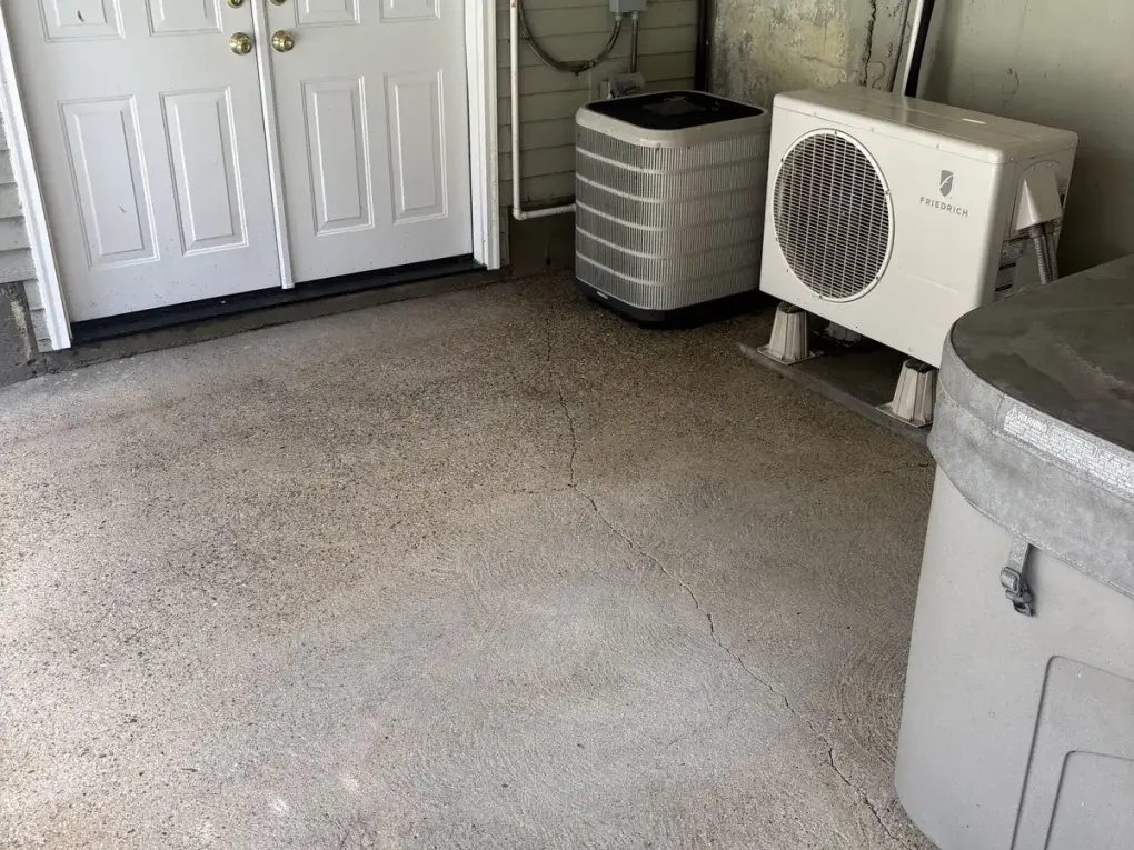 Clean concrete patio next to AC units after professional pressure washing in Upton MA