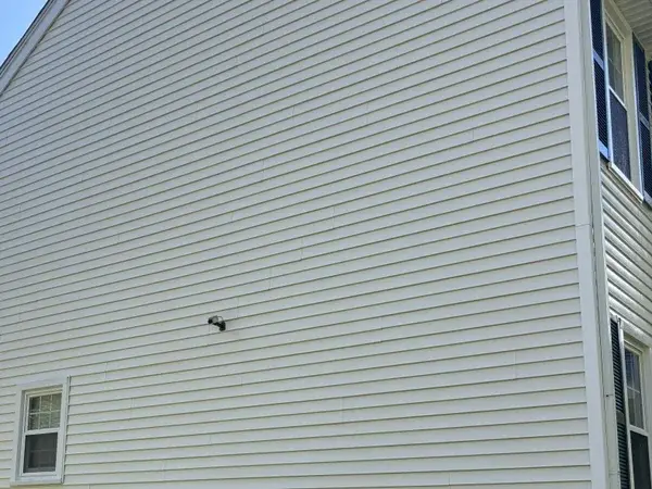 Clean bright vinyl siding after professional soft wash house washing in Mendon MA