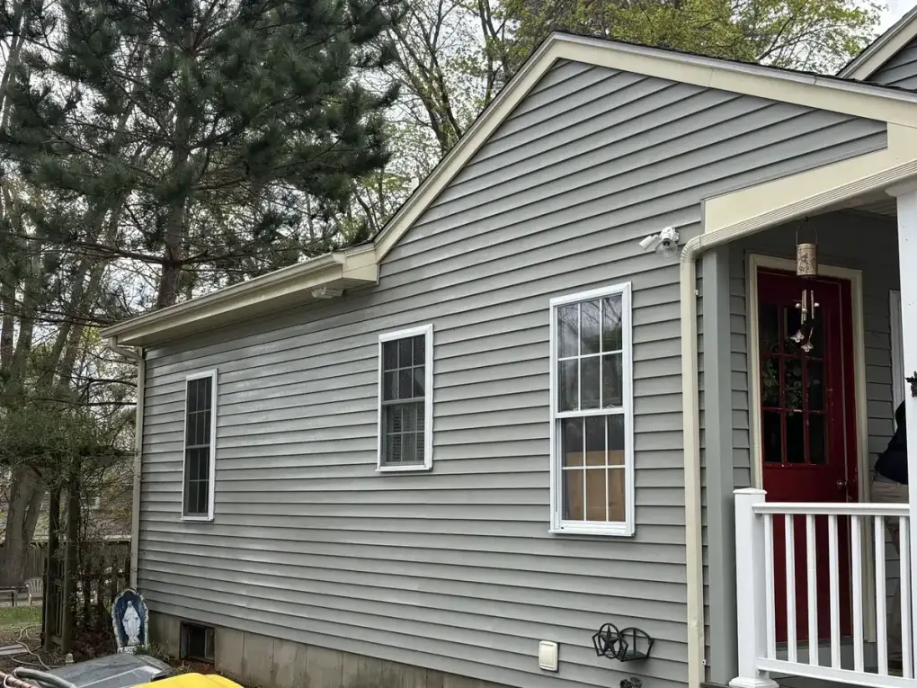Clean gray vinyl siding after professional soft wash house washing in Franklin MA