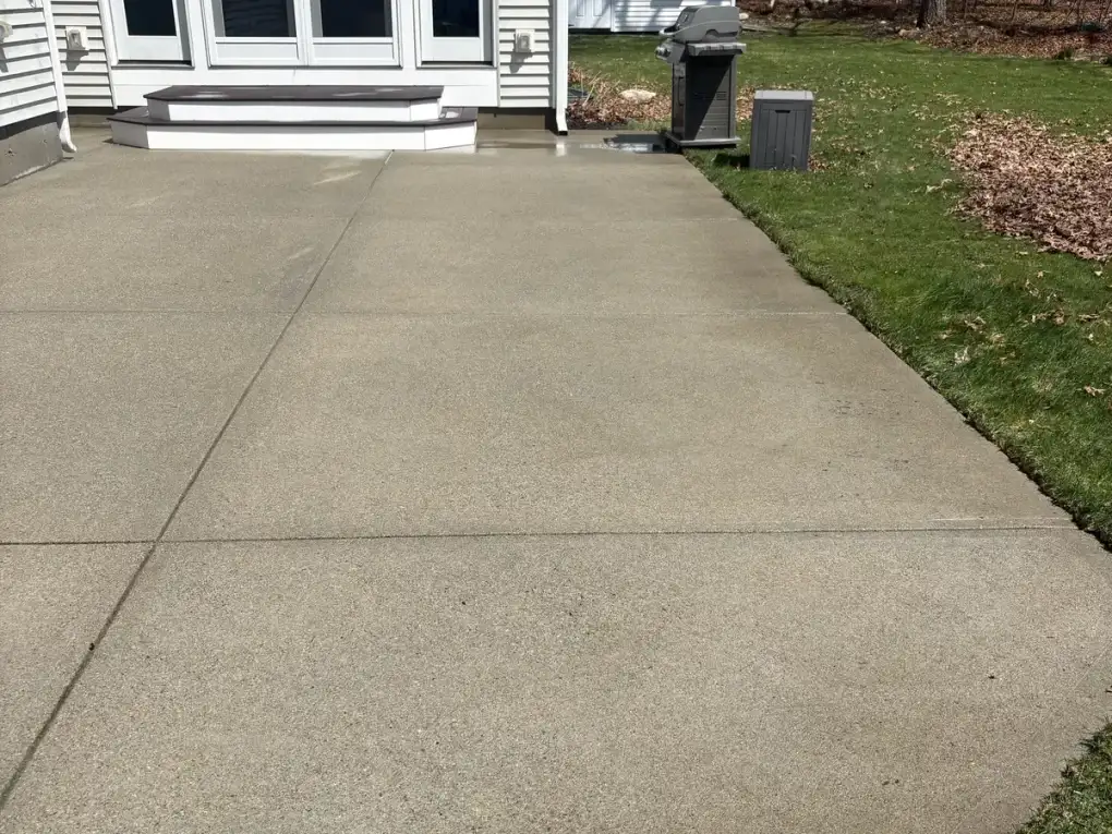 Clean bright concrete patio after professional power washing in Mansfield MA