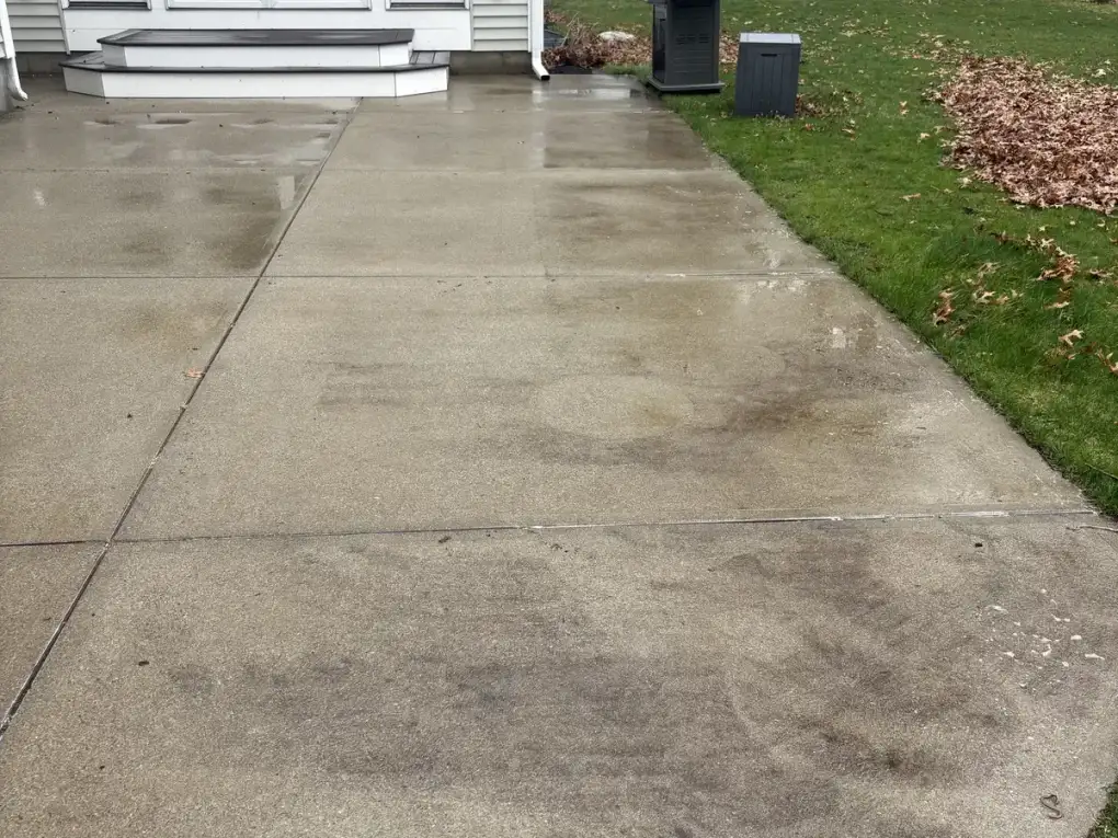 Stained concrete patio with dirt and discoloration before power washing in Mansfield MA