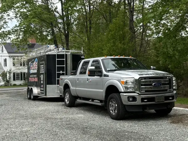 Drake Power Washing service truck and branded trailer parked at a Blackstone Valley job site