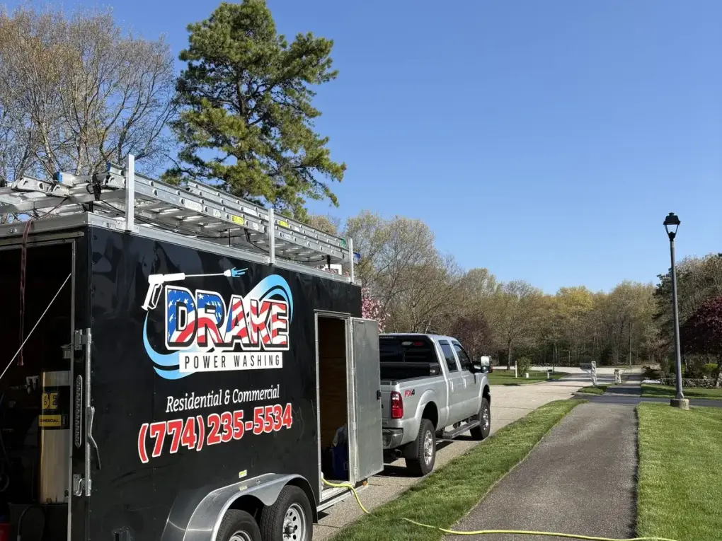 Drake Power Washing branded enclosed trailer and Ford F-250 service truck on a residential job in MetroWest Boston Massachusetts