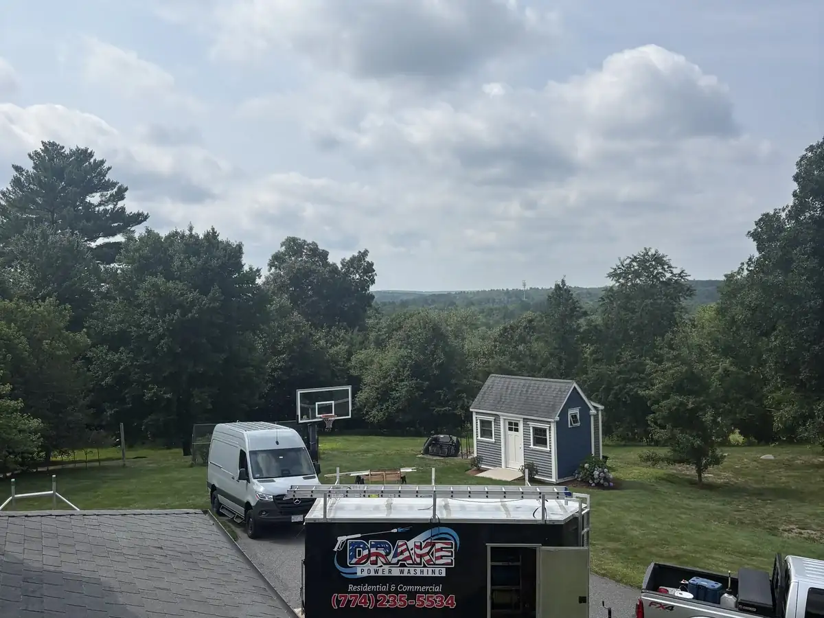 Drake Power Washing van and trailer on-site at a roof washing job in Northbridge MA