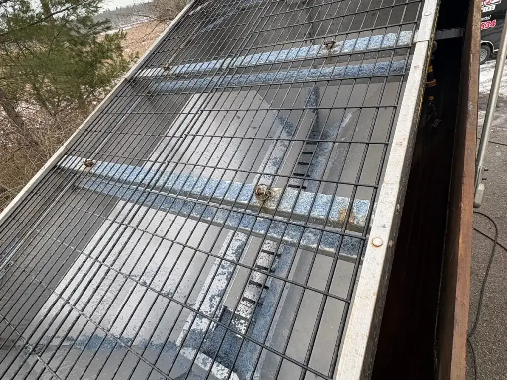 Industrial metal grating before professional cleaning - covered in grime