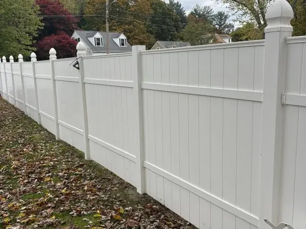 Bright white vinyl fence after professional power washing