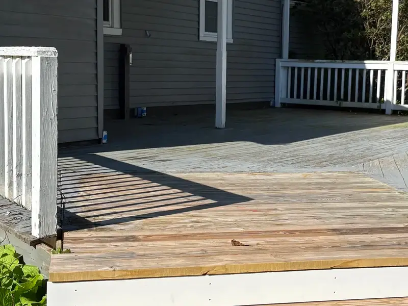 Weathered deck before restoration - faded and damaged wood
