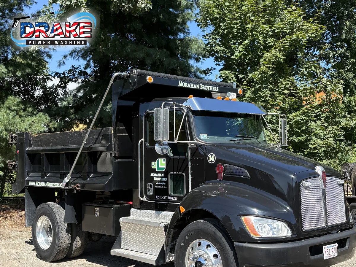 Front view of a clean commercial dump truck after fleet washing in Medfield