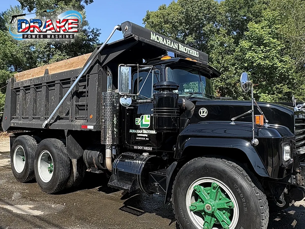 Clean black commercial dump truck after mobile fleet washing in Medfield Massachusetts