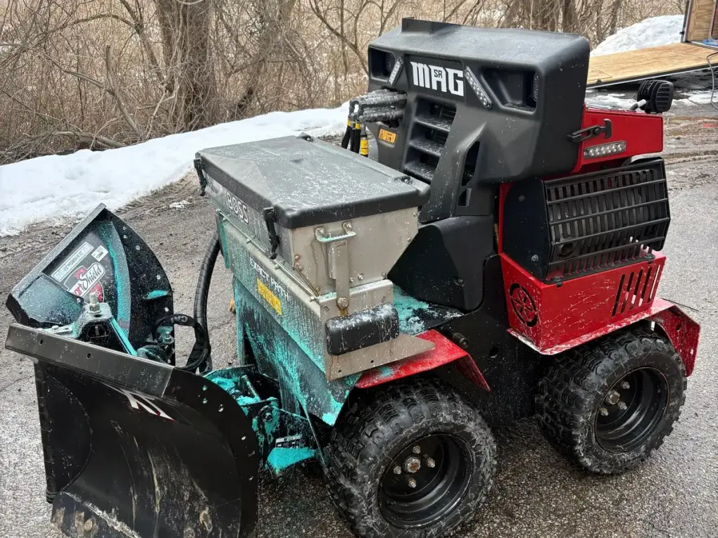 Snow plow equipment covered in salt and ice before washing