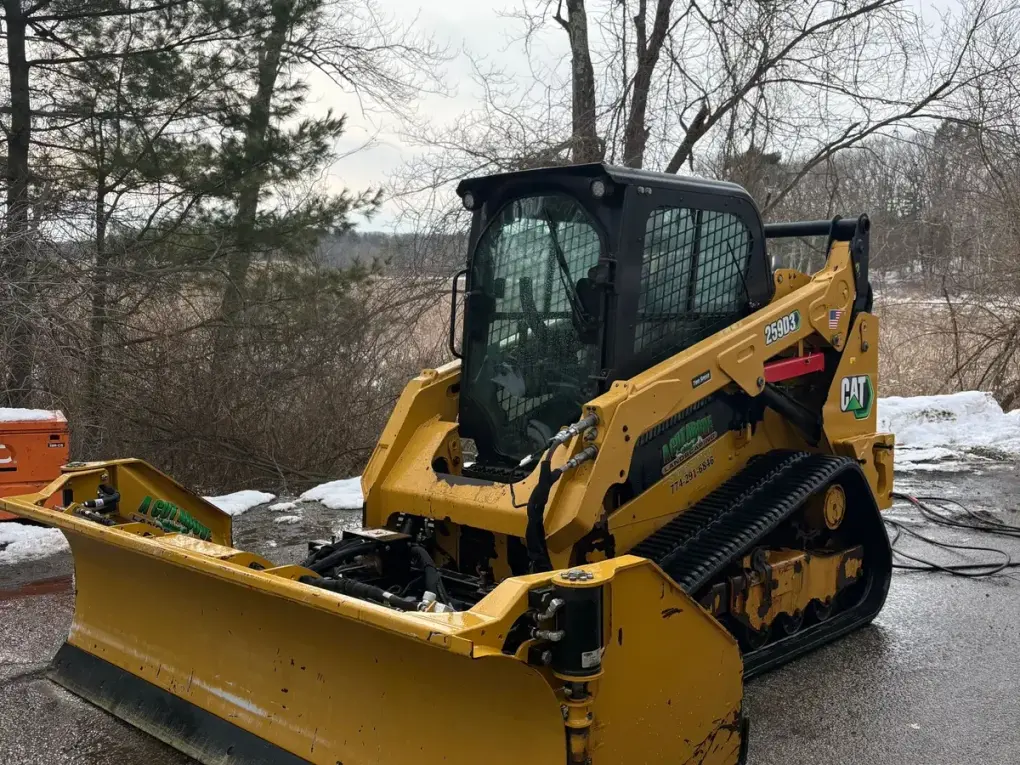 CAT 259D3 skid steer with snow plow attachment - Drake Power Washing commercial snow removal equipment