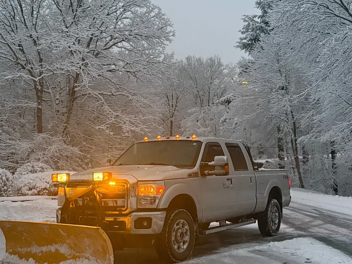Drake Power Washing snow plow truck ready for winter storm service in snowy Massachusetts