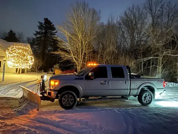 Drake Power Washing snow plowing truck in action at night